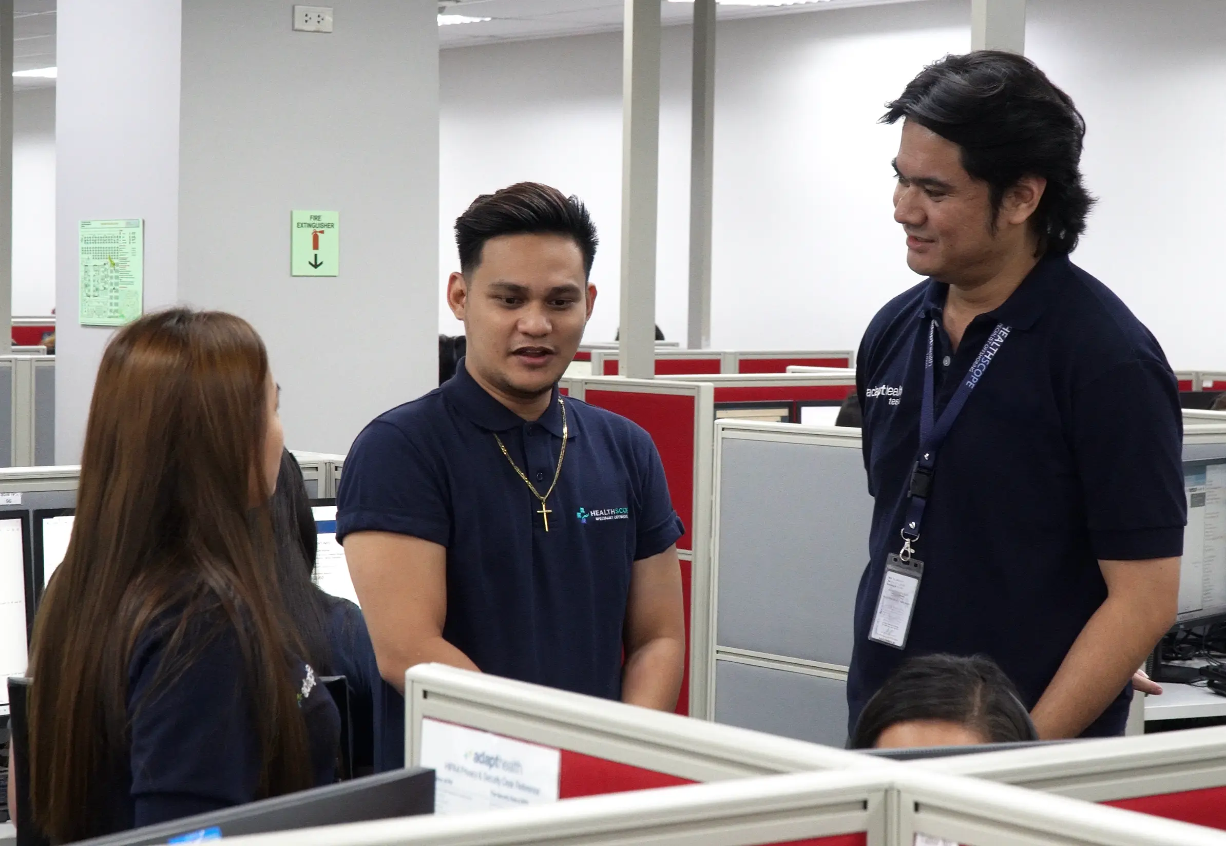 Healthscope team members talking in the Philippine operations center